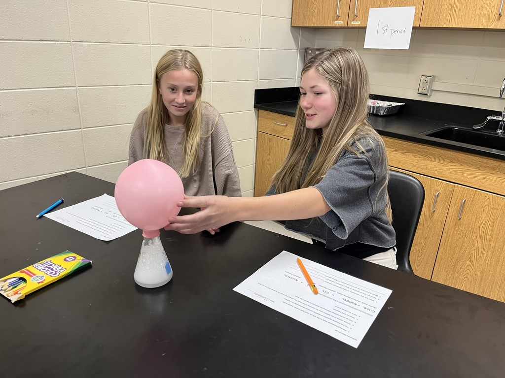 In Mrs. Bryant’s science class, students experimented with acetic acid and sodium carbonate. When these two reactants were combined inside a balloon, they produced water, carbon dioxide, and sodium acetate — causing the balloon to inflate!  Students observed that the mass of the reactants equaled the mass of the products, demonstrating the Law of Conservation of Matter. ⚗️💙💛  #HarrisonMiddleSchool #GreatGoblins #HMSScience #HandsOnLearning #STEMFun #ConservationOfMatter