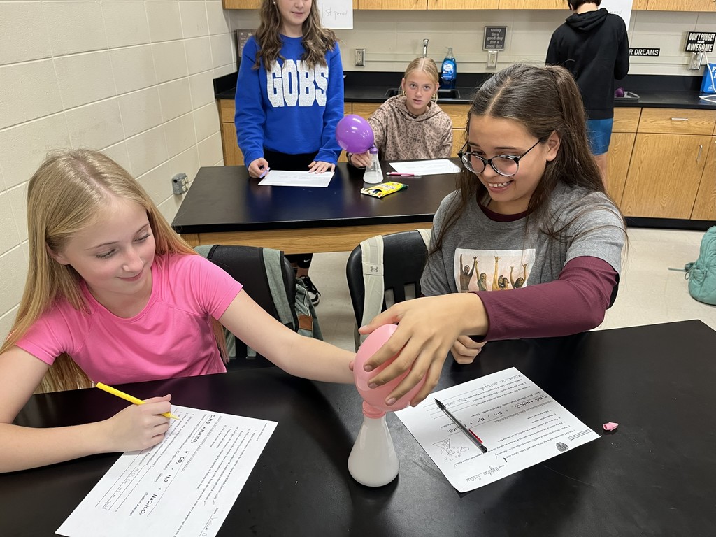 In Mrs. Bryant’s science class, students experimented with acetic acid and sodium carbonate. When these two reactants were combined inside a balloon, they produced water, carbon dioxide, and sodium acetate — causing the balloon to inflate!  Students observed that the mass of the reactants equaled the mass of the products, demonstrating the Law of Conservation of Matter. ⚗️💙💛  #HarrisonMiddleSchool #GreatGoblins #HMSScience #HandsOnLearning #STEMFun #ConservationOfMatter