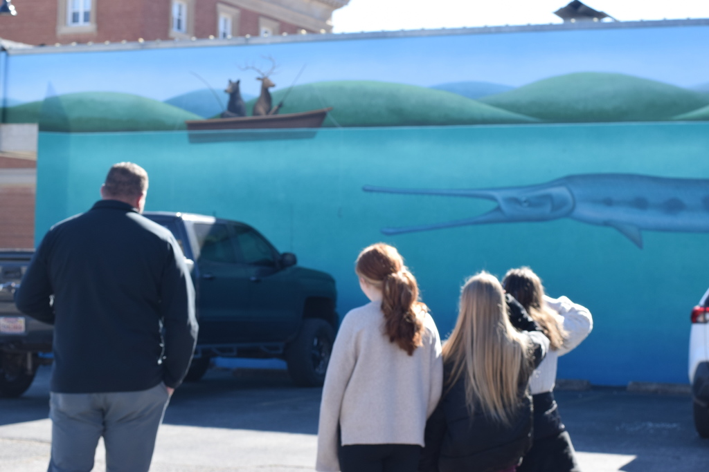 🎨📱 Mural Tech in Action! Students working on the EAST Project Mural Tech partnered with Explore Harrison’s Matt Bell for a productive day in Downtown Harrison. During a guided walking tour of the city’s murals, students collaborated with Mr. Bell to plan Phase 1 of the project—adding plaques with QR codes and informative details to each mural.  It was a beautiful day to learn, collaborate, and connect art with technology! A big thank-you to Matt Bell for sharing his time and expertise, and to Boba Joe’s for the treats that made the day even sweeter.  #EASTProject #MuralTech #ExploreHarrisonAR #DowntownHarrison #StudentCollaboration #ArtMeetsTechnology #CommunityPartnership #LearningBeyondTheClassroom #QRinAction #ThankYou
