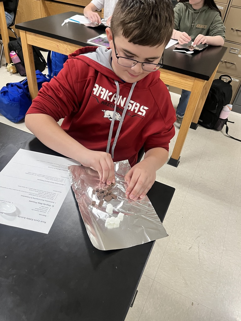 Today in class, students explored the rock cycle in a hands-on (and delicious!) way! 🍫🔥 Using marshmallows, Hershey chocolate bars, and tinfoil, students modeled how rocks change over time. By applying pressure with their hands and using heat from an iron and a toaster oven, they were able to recreate the three main types of rocks:  🪨 Sedimentary – pressing the materials together 🔥 Metamorphic – adding heat and pressure 🌋 Igneous – melting and cooling  This lab helped students see that: ➡️ Energy flows through the system (heat and pressure drive change) ➡️ Matter cycles (the same materials are reused and never lost)  Students discovered that the rock cycle has no true beginning or end—just continuous change!  Hands-on learning + real-world connections = a great day in science! 👏 #RockCycle #HandsOnLearning #7thGradeScience