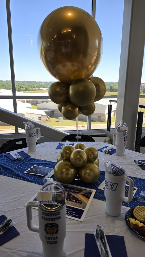 decorated table with balloons, mugs, etc.