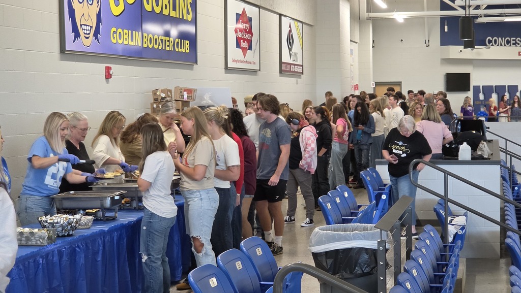 students being served breakfast