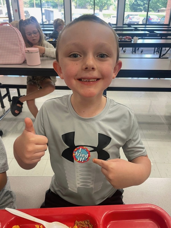 student giving thumbs up