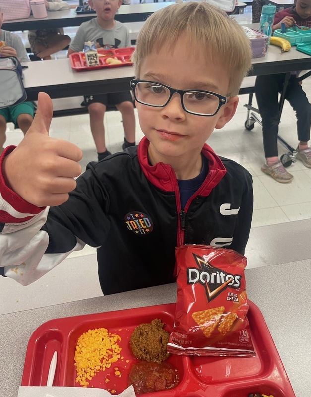 student giving thumbs up