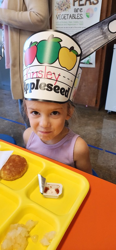 student wearing "johnny appleseed" hat