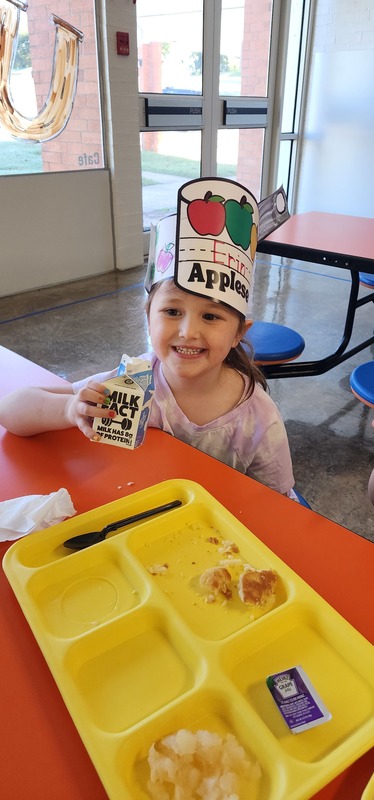 student wearing "johnny appleseed" hat