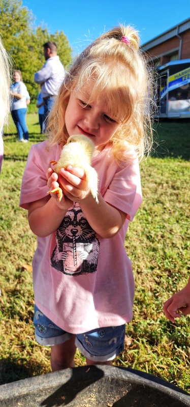 student with baby chick