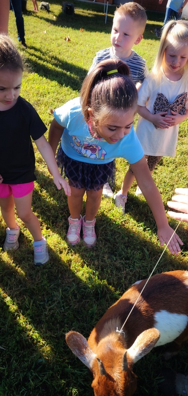 student petting goat