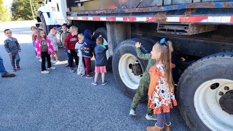 Students in front of dump truck