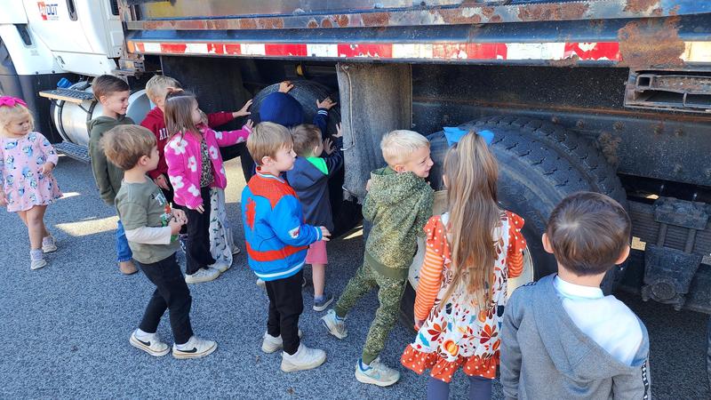 Students in front of dump truck