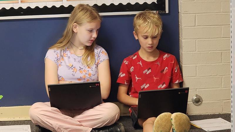 students at work on podcasts