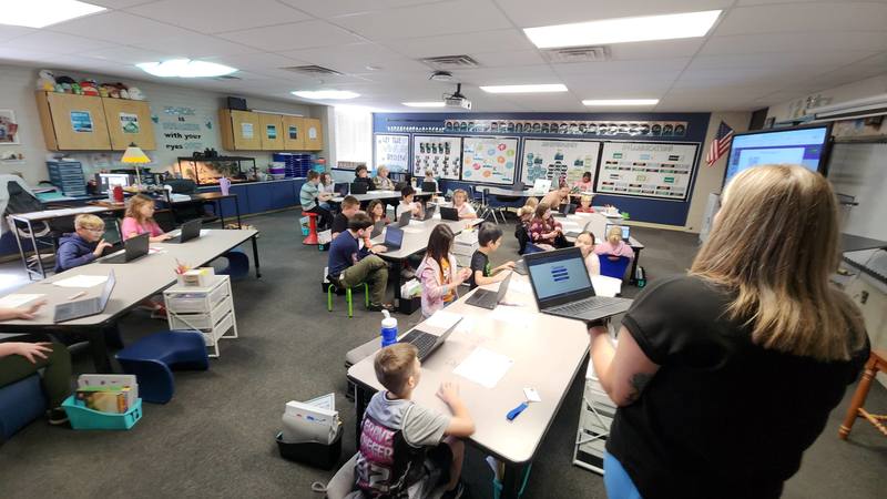 students at work on podcasts