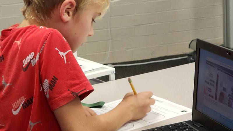 students at work on podcasts