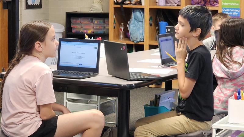 students at work on podcasts