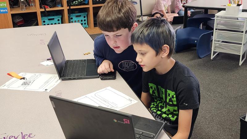 students at work on podcasts