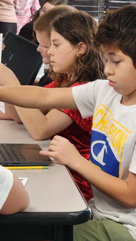 students at work on podcasts