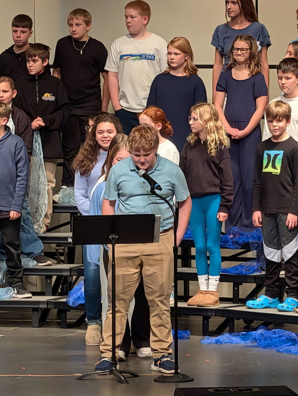 students performing on stage