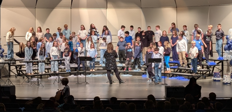 students performing on stage