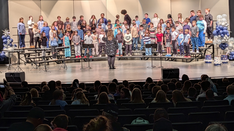 students performing on stage