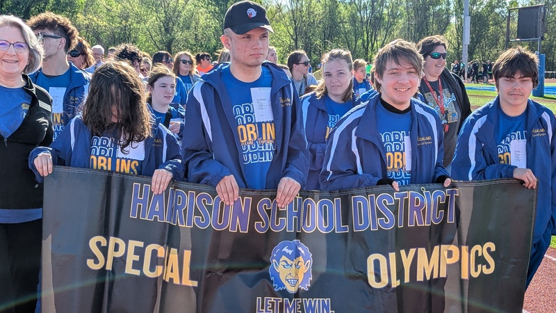 Special Olympians carrying banner