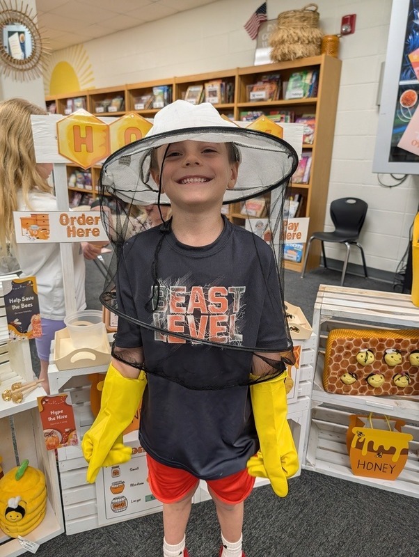 student in beekeeper outfit