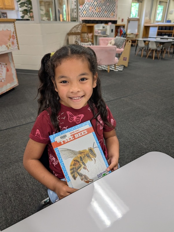 student with book about bees