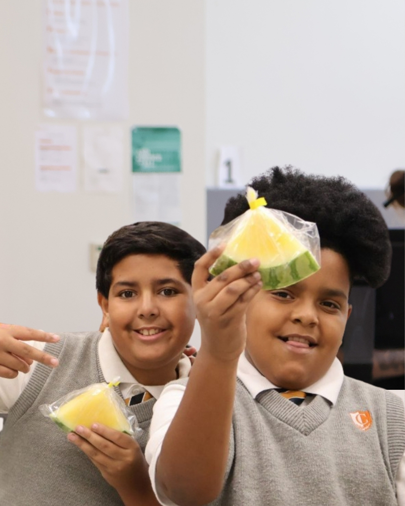 Two Students with locally grown produce