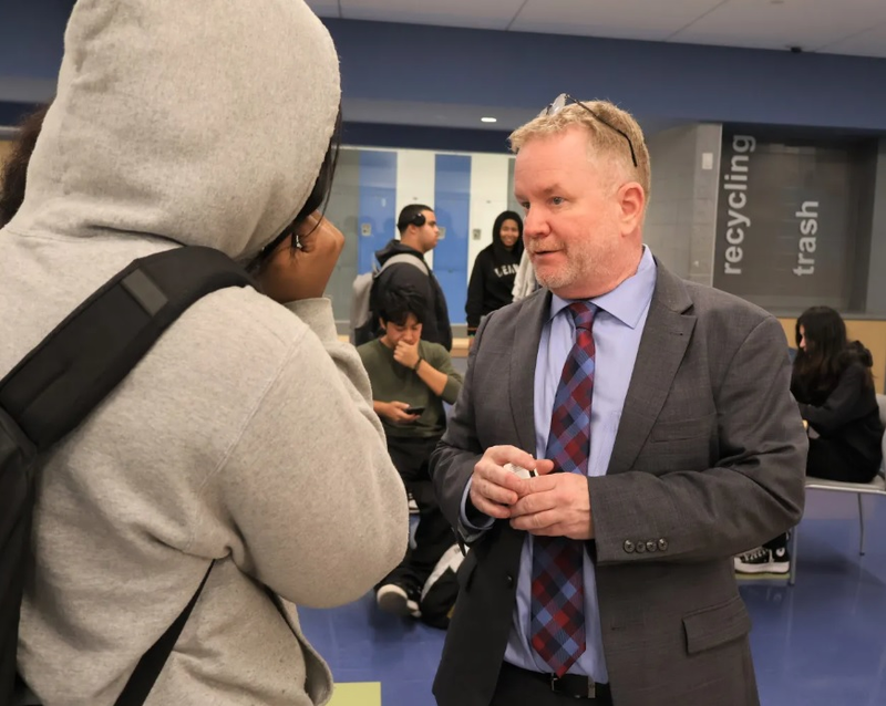 Principal Sean Tomany handing out passes at Weaver High School