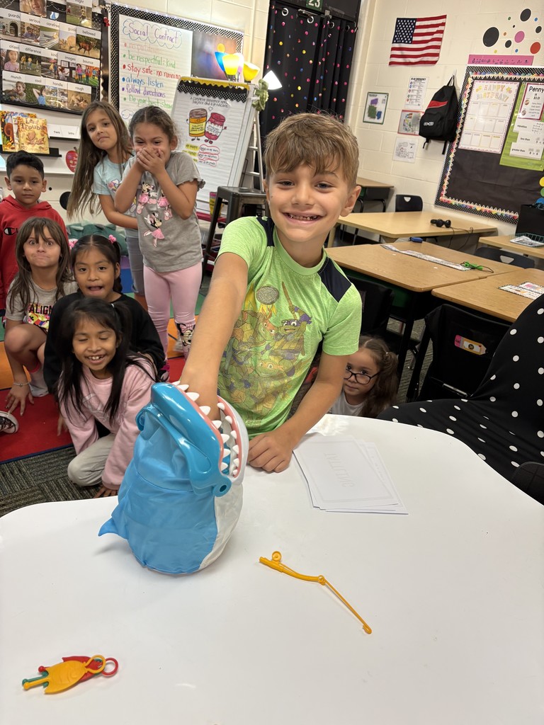 a student with a shark toy