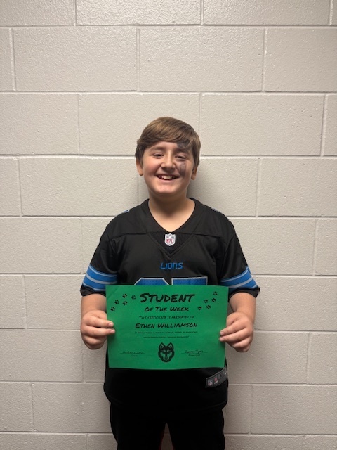 e. williamson holding his student  of the week sign