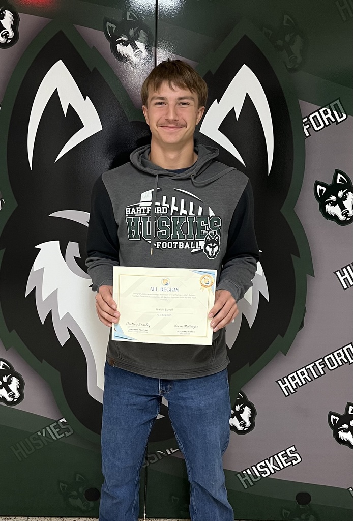photo of HHS student Isaiah Lovell holding his all region football award