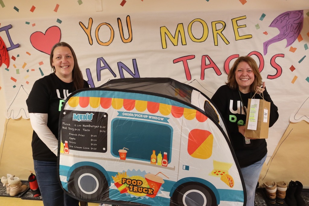 teacher pose with the reading month taco truck