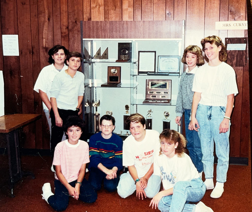 A collection of vintage Hartford Public Schools photographs featured in Hartford Rewind | Volume 2. The images include students posing with academic trophies, science classroom activities, elementary students reading and participating in class, hands-on classroom projects, cultural learning activities, CPR training, group class photos, Adult Education displays at a community event, students gathered outdoors, and various classroom and school life scenes from past decades. The photographs capture everyday moments, learning experiences, and student life throughout Hartford Public Schools' history.