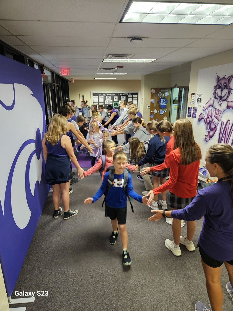 Cross Country athletes greeting elementary students