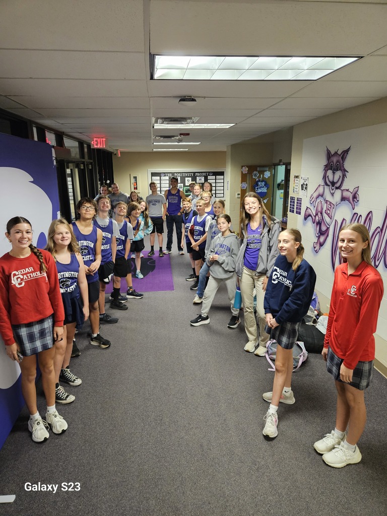 Cross Country athletes greeting elementary students