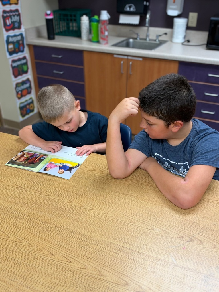 Buddy Readers: 4th and 1st graders read together.