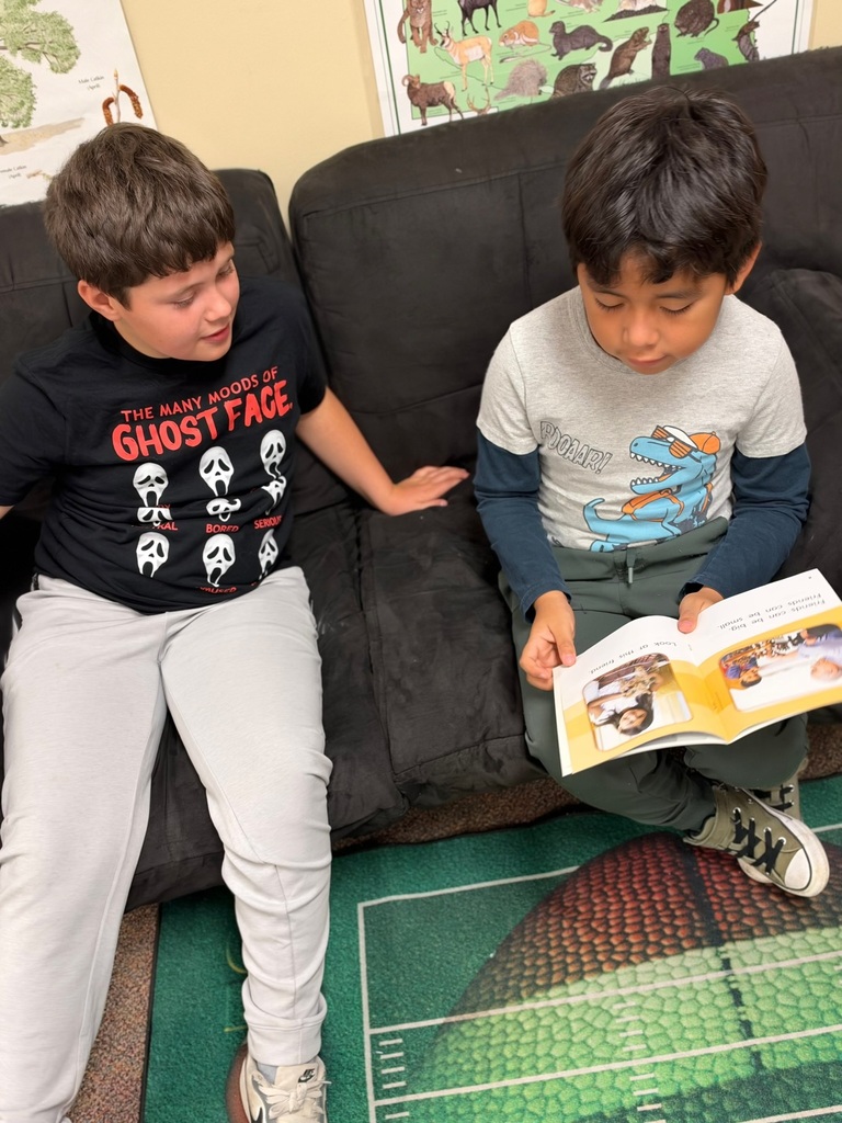 Buddy Readers: 4th and 1st graders read together.