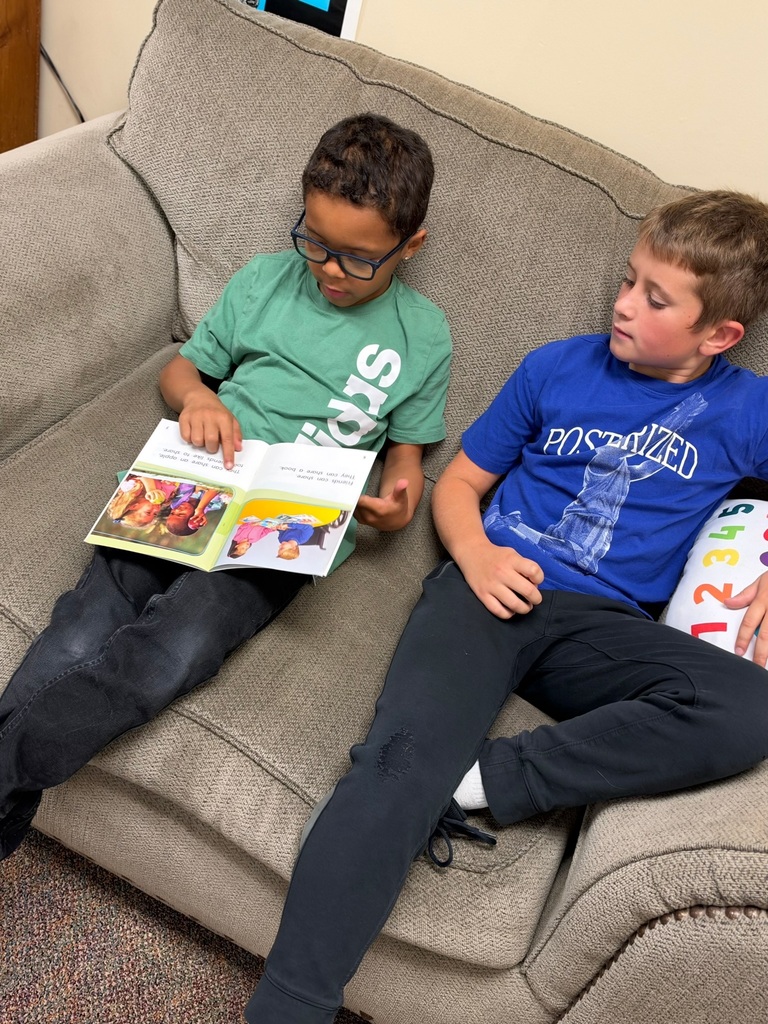 Buddy Readers: 4th and 1st graders read together.
