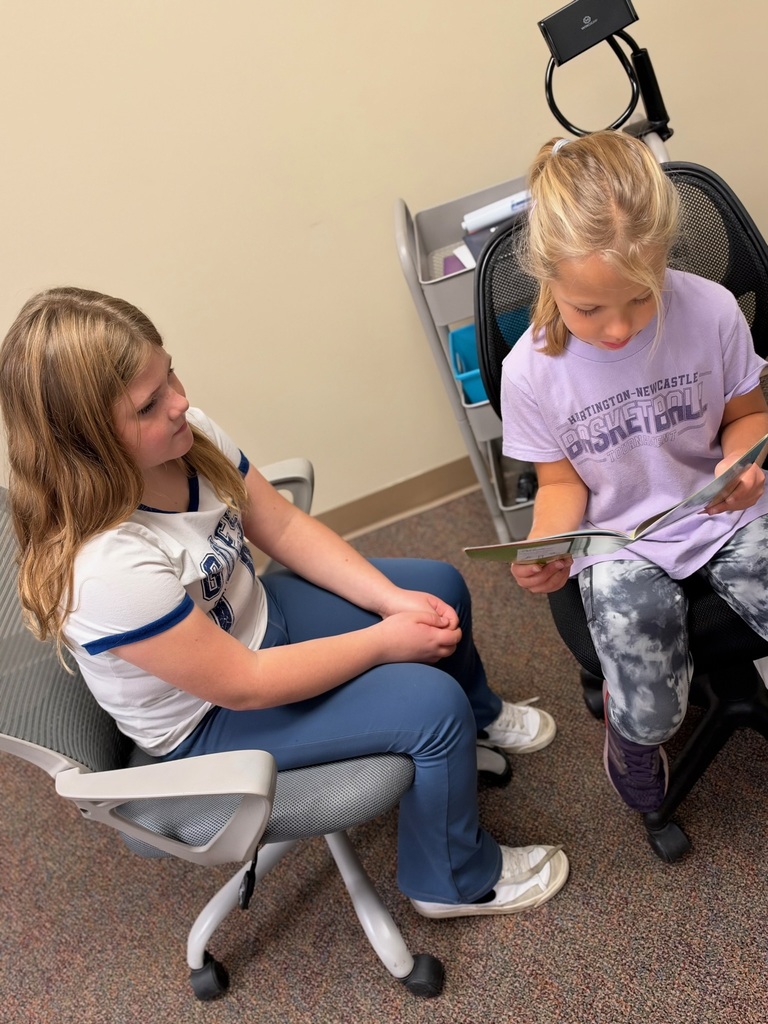 Buddy Readers: 4th and 1st graders read together.