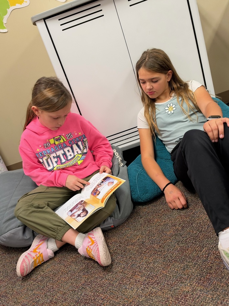 Buddy Readers: 4th and 1st graders read together.