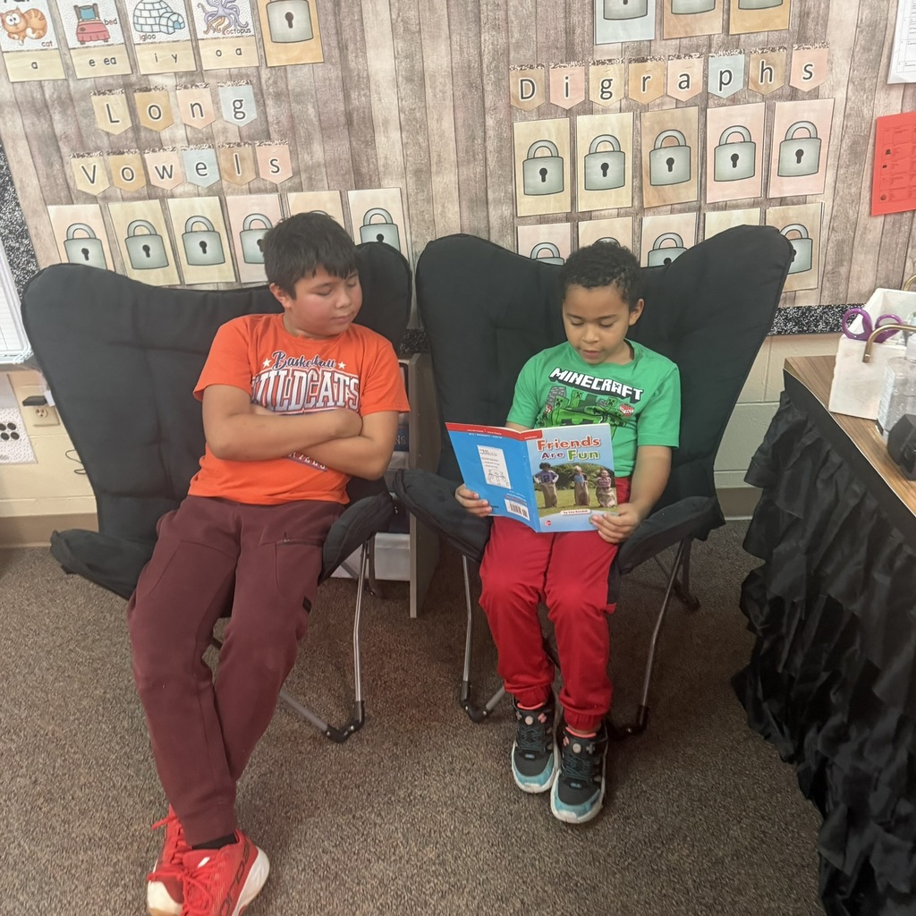 Buddy Readers: 4th and 1st graders read together.