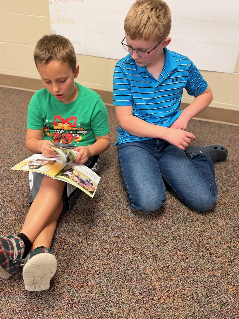 Buddy Readers: 4th and 1st graders read together.