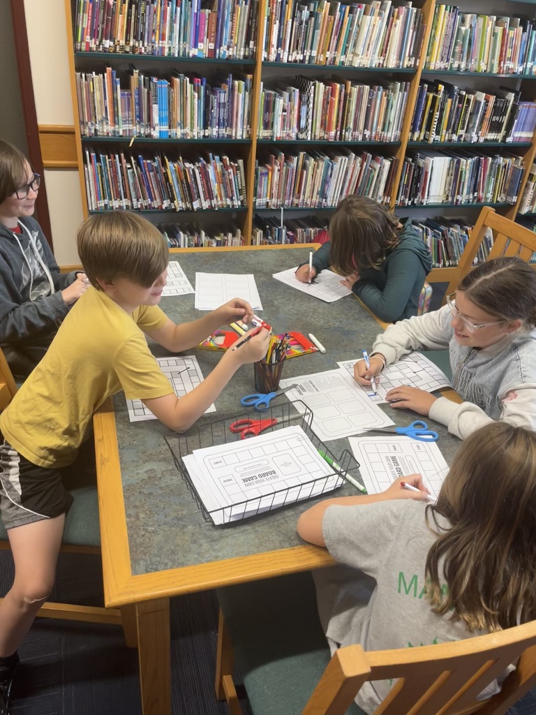 kids at table working on paper.