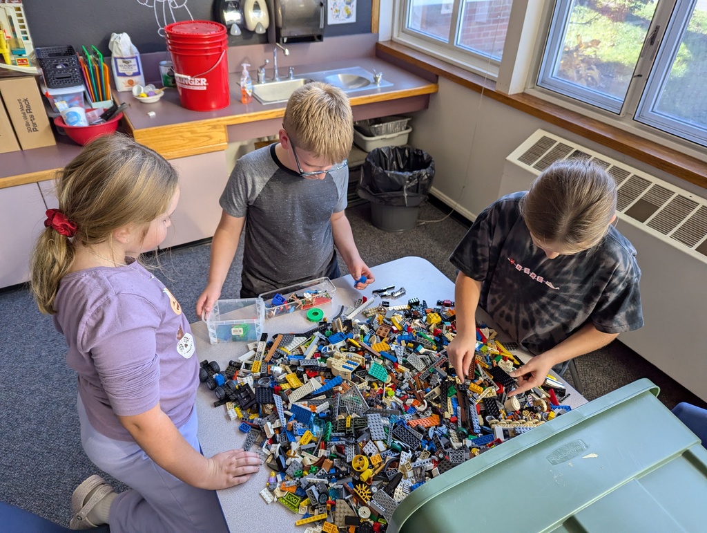 Kids standing at table with Legos