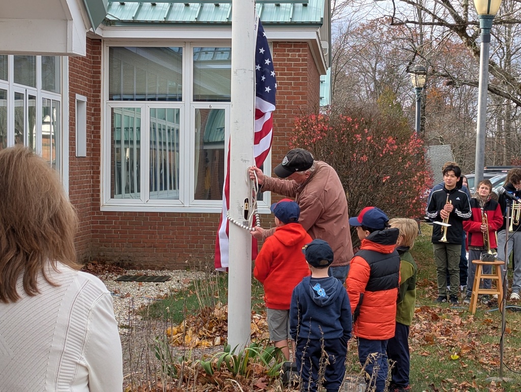 Students helping to raise the flag