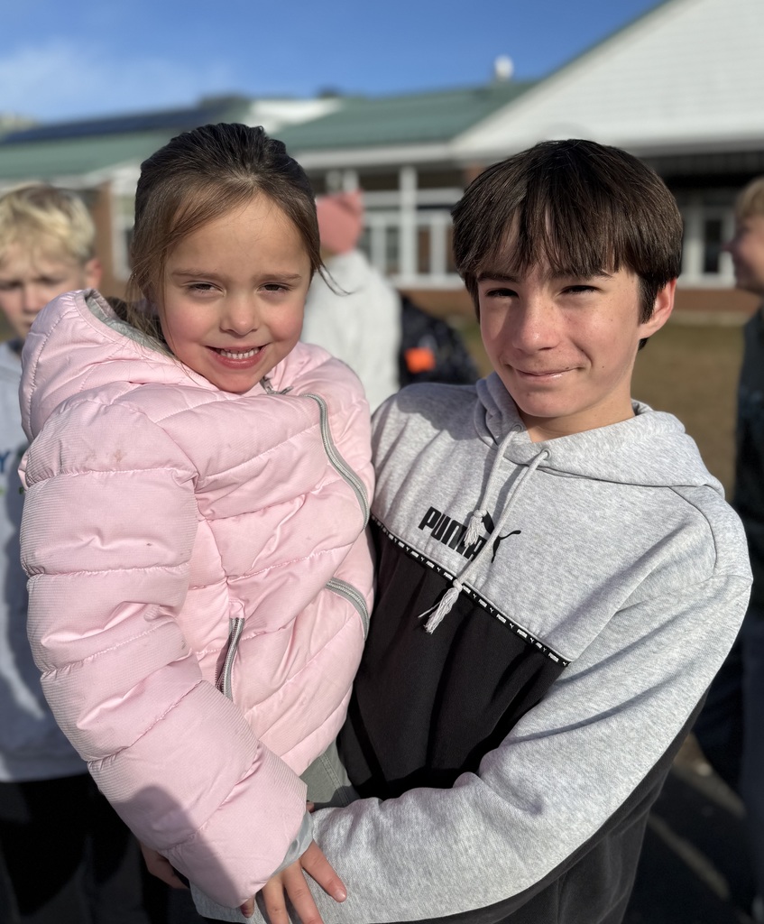 Older boy holding younger girl.