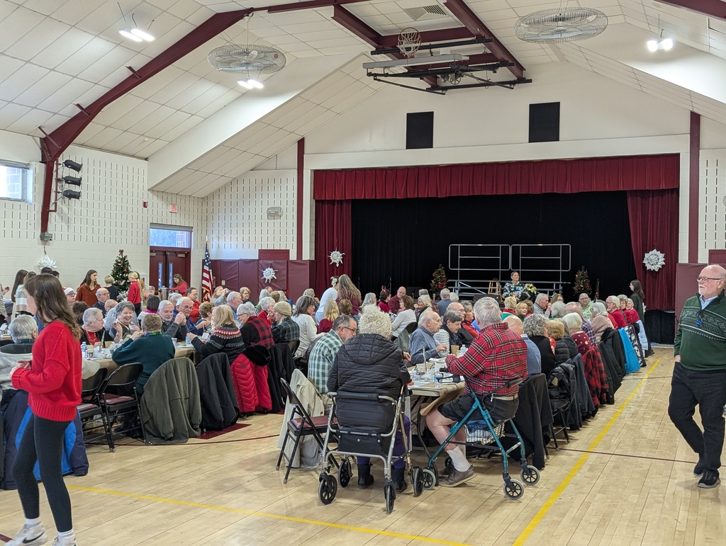 Seniors sitting at tables in the gym