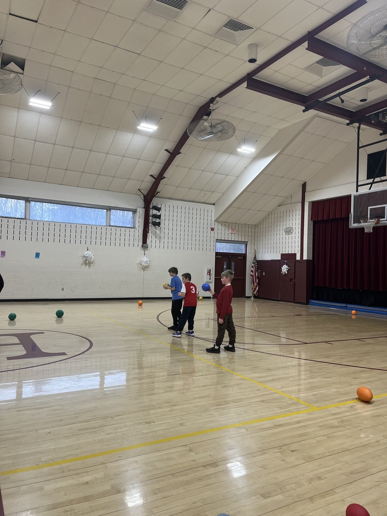 Kids in gym about to throw a ball