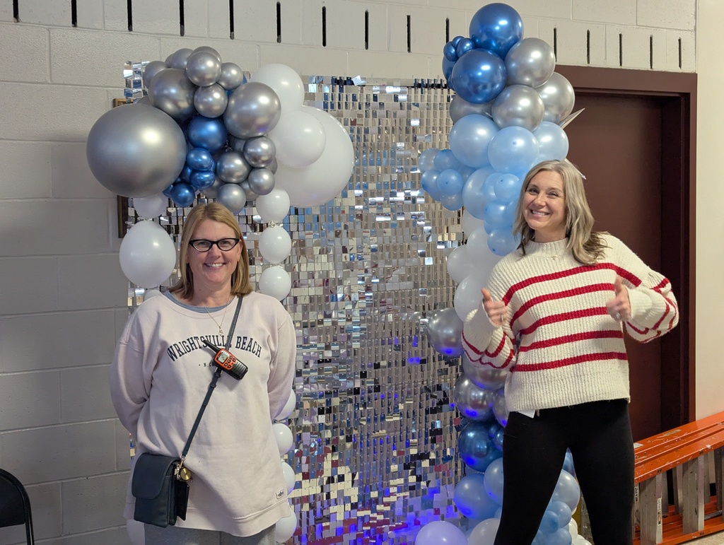 teachers in front of dance arch