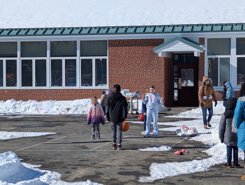 kids playing with basketball on snowy playground